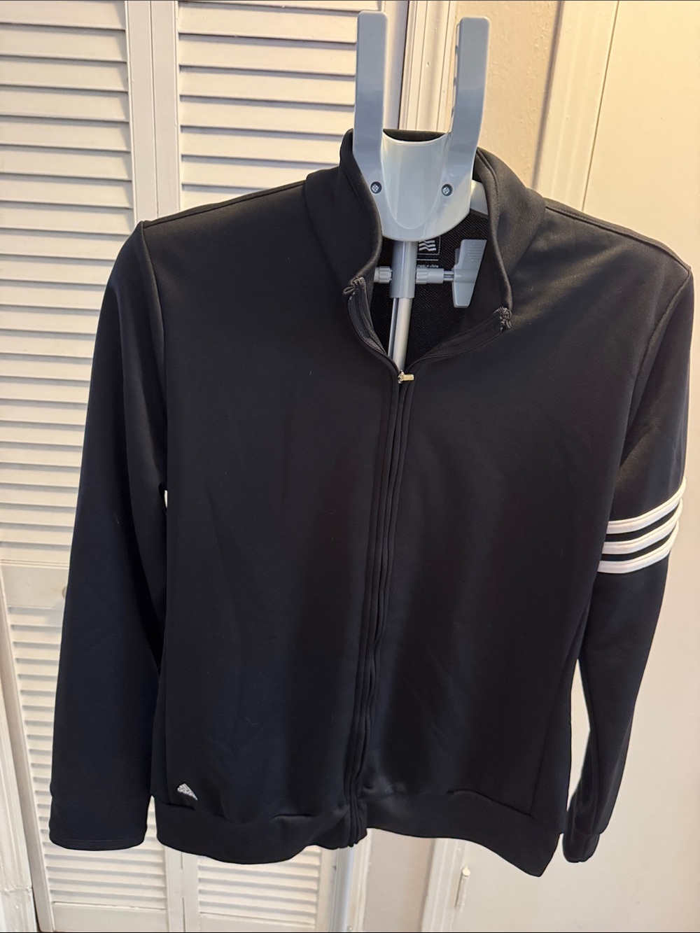 adidas women’s Black zip up golf jacket with White Logo and stripes